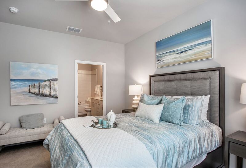 large, modern bedroom decorated with beach decor at terraces at peridia